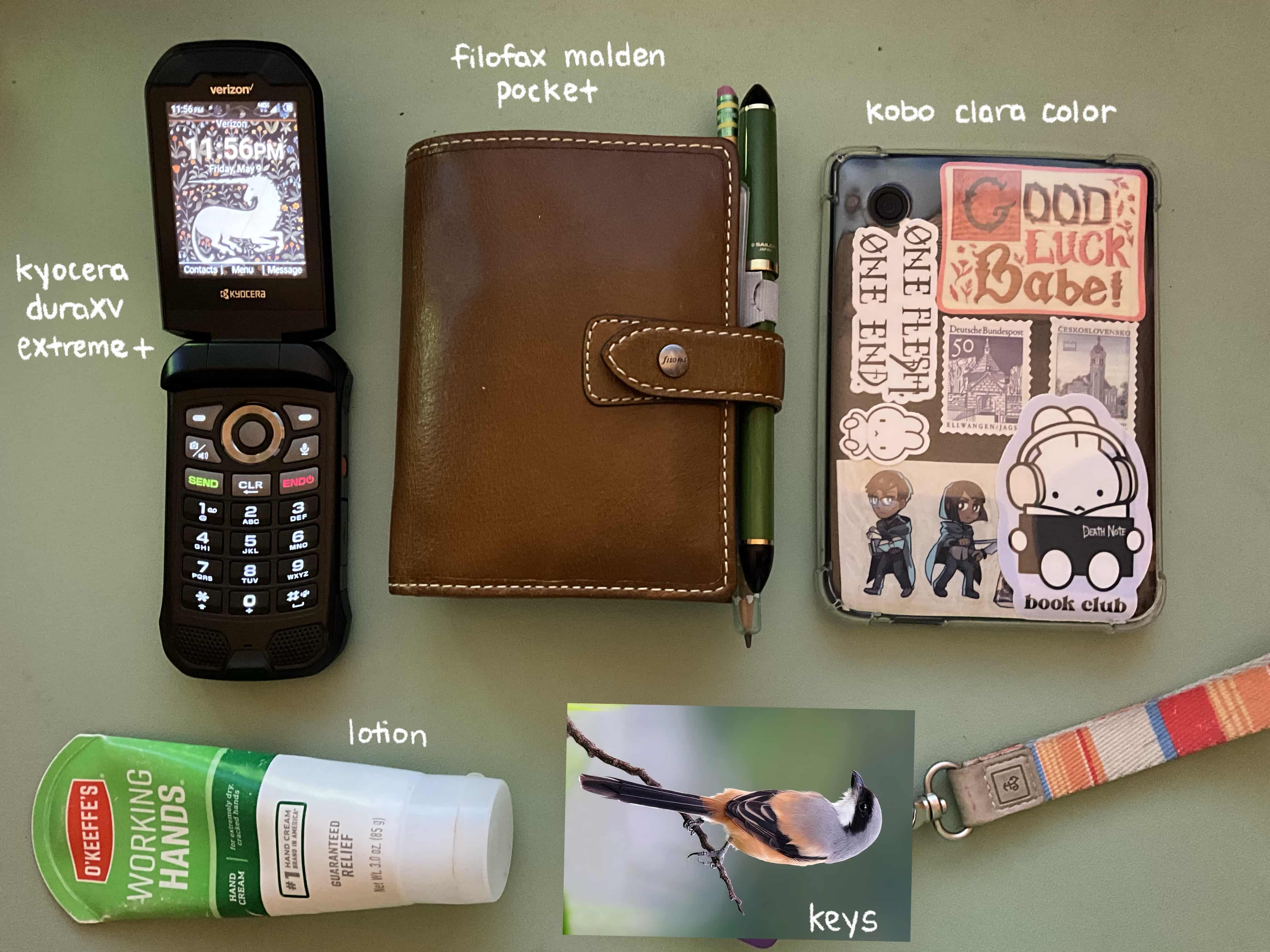 Kyocera DuraXV Extreme+ flip phone, Filofax Malden Pocket, Kobo Clara Color, keys, lotion